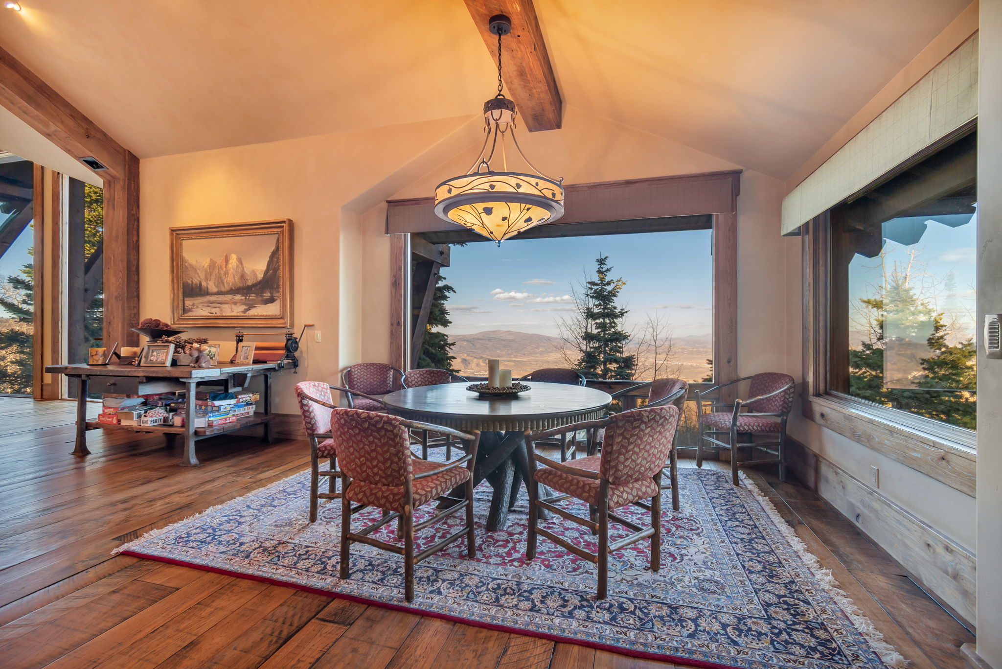 Dining area with expansive windows featuring mountain and valley scenery
