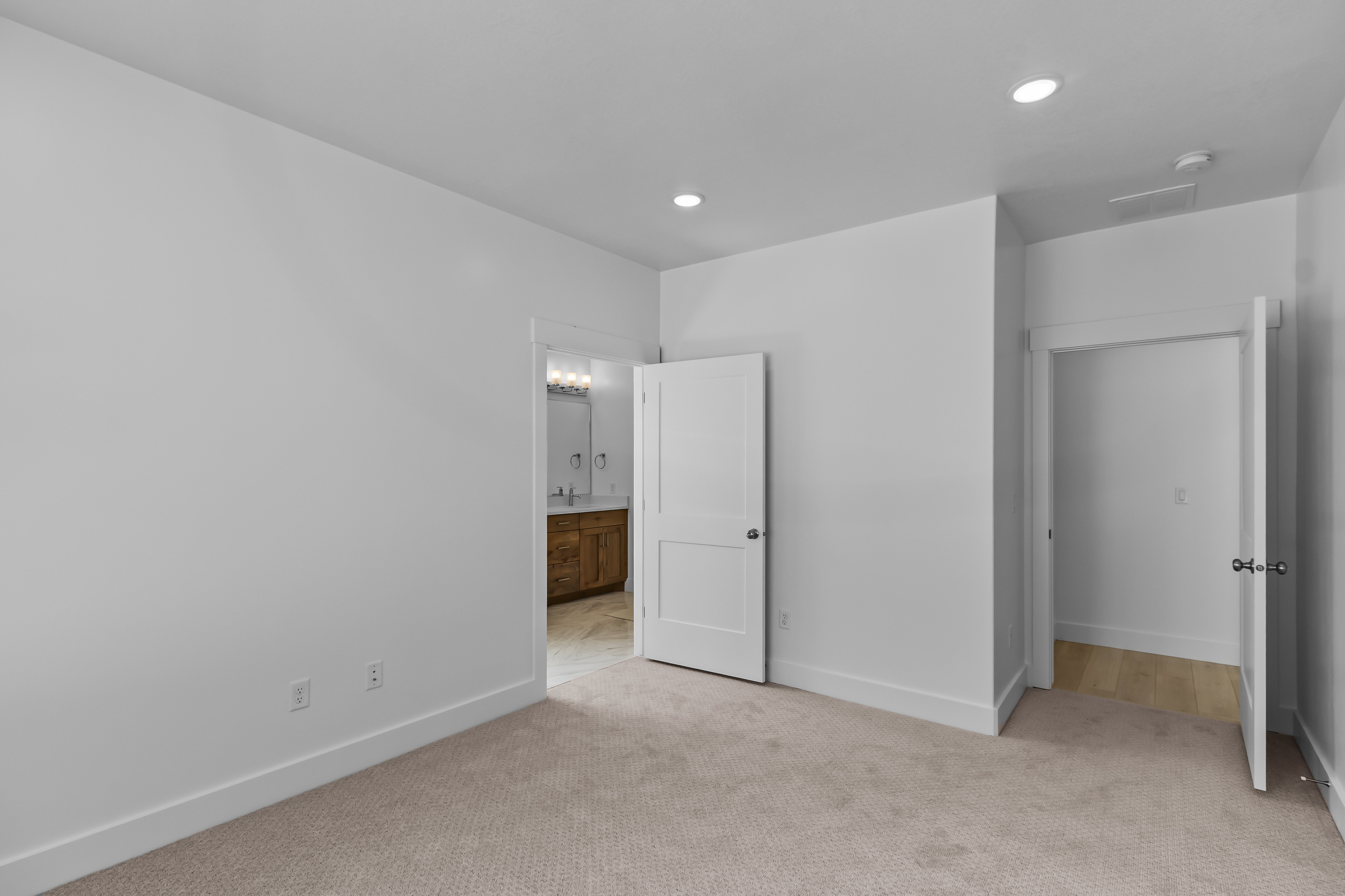 Spacious room featuring neutral carpeting and recessed lighting