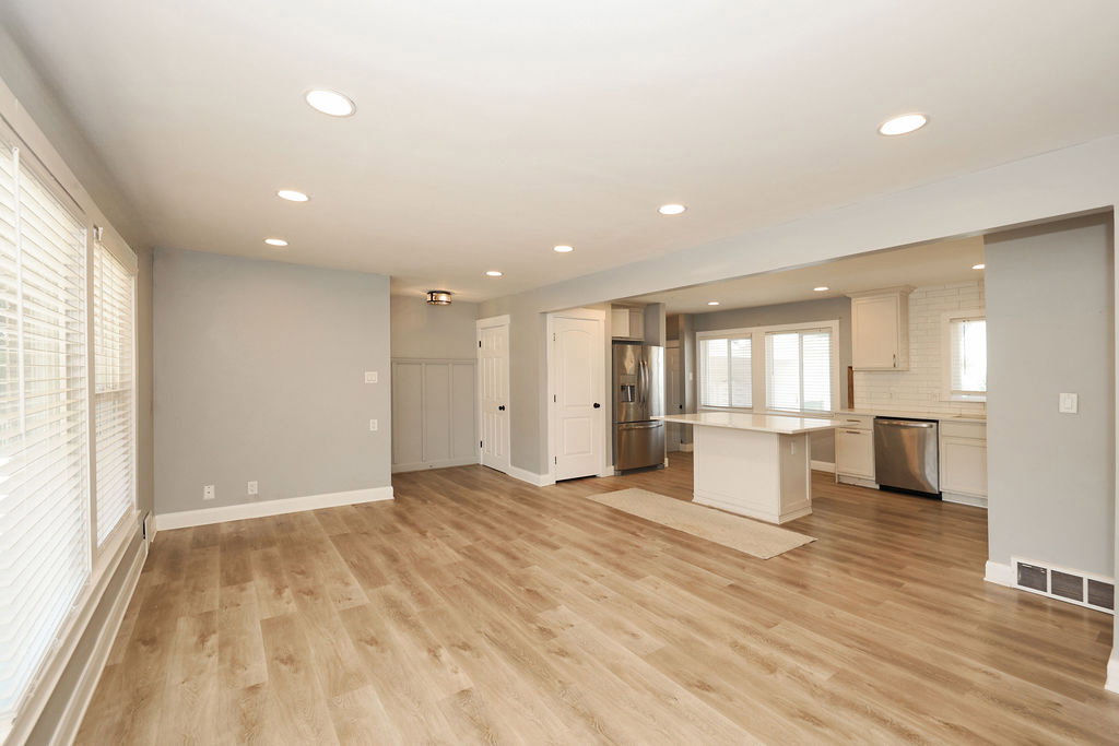 Open-concept living space featuring wood-finish flooring, recessed lighting, and light gray wall tones