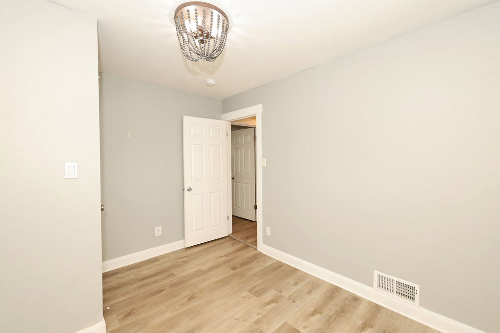 Light wood-finish flooring complements the neutral wall color in this versatile room