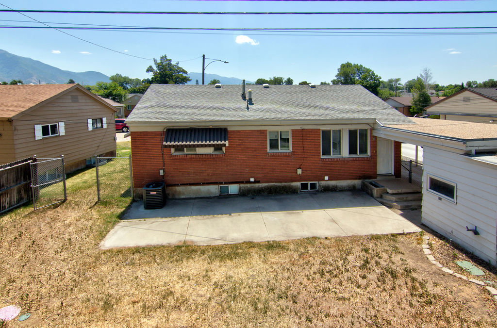 Brick exterior with a gray asphalt shingle roof
