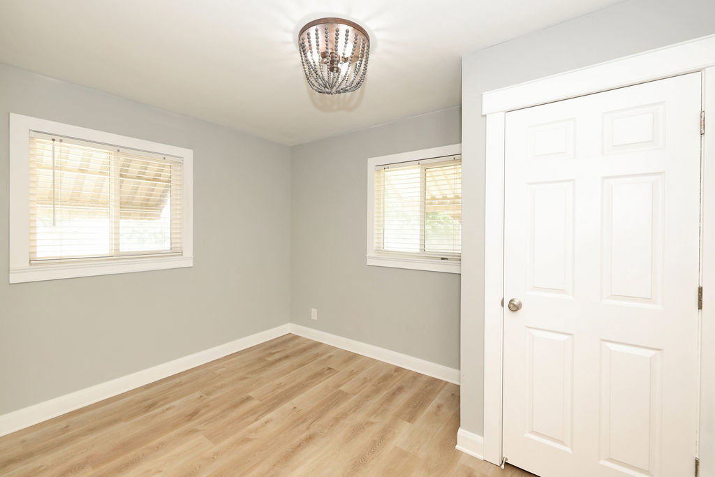 Light wood-finish flooring complements the neutral wall color