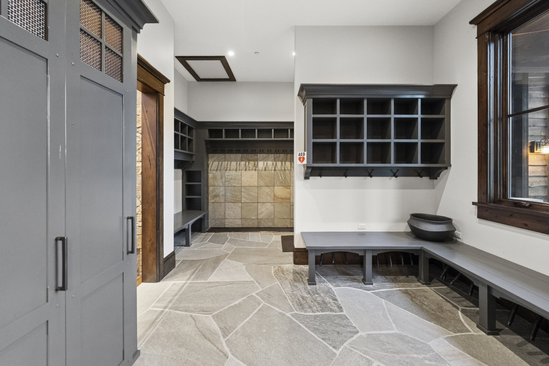 Entryway featuring flagstone flooring and built-in storage solutions