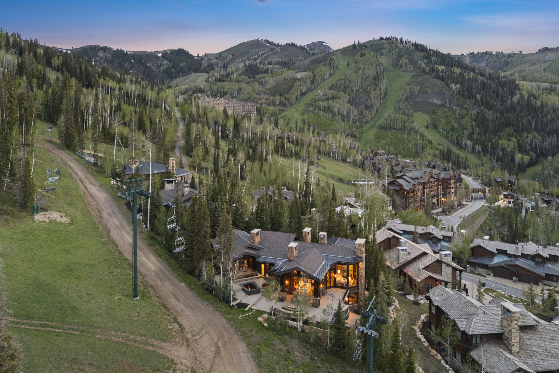 Mountain property featuring extensive exterior stonework, numerous chimneys, and a multi-level roofline