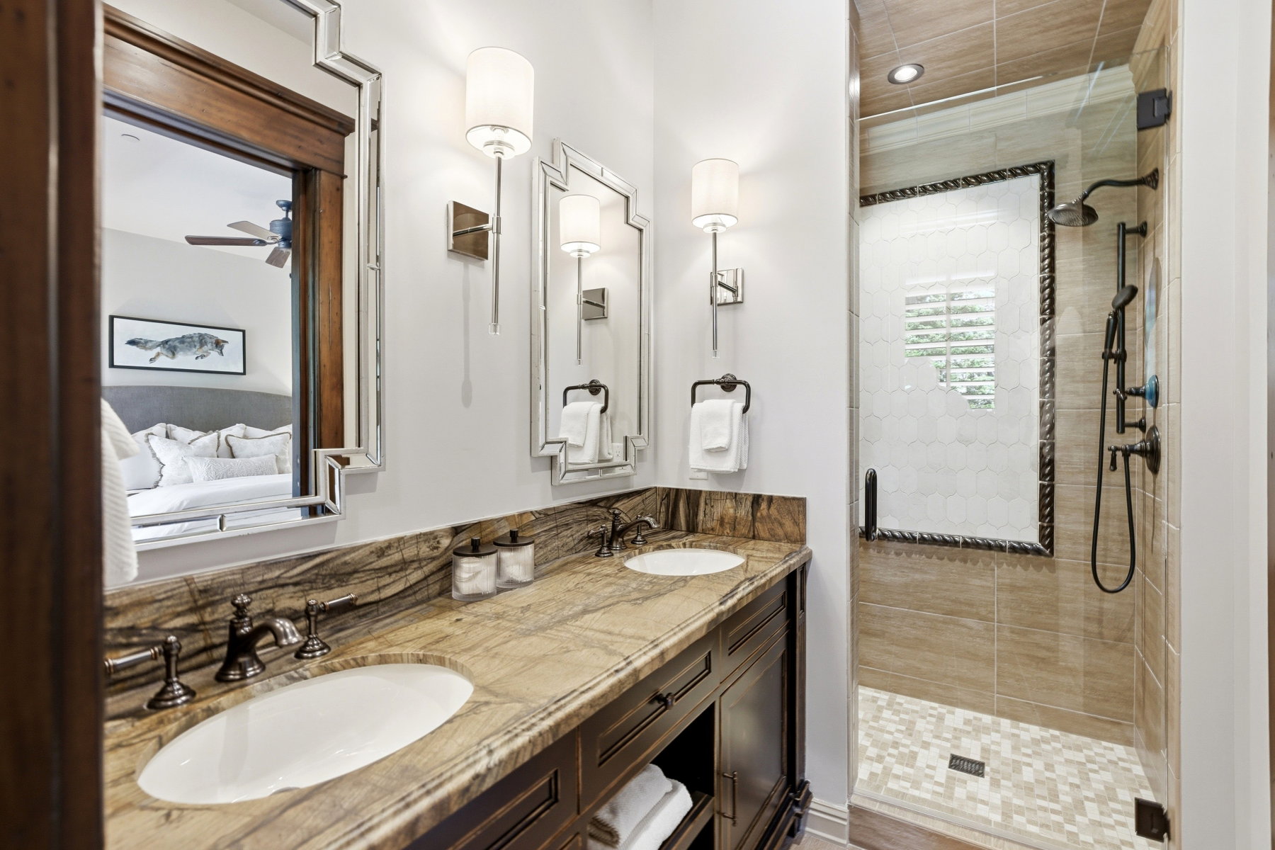 Double vanity featuring an integrated countertop with two undermount sinks and bronze-finish fixtures