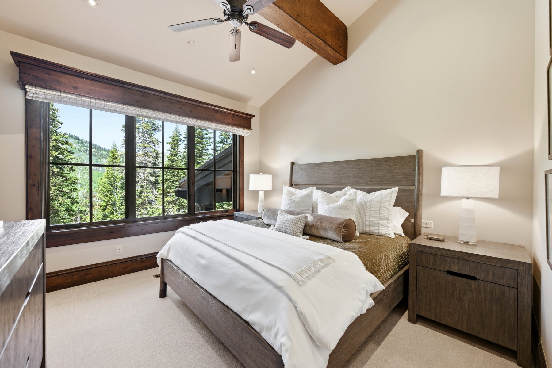 Vaulted ceiling with exposed wood beam and ceiling fan