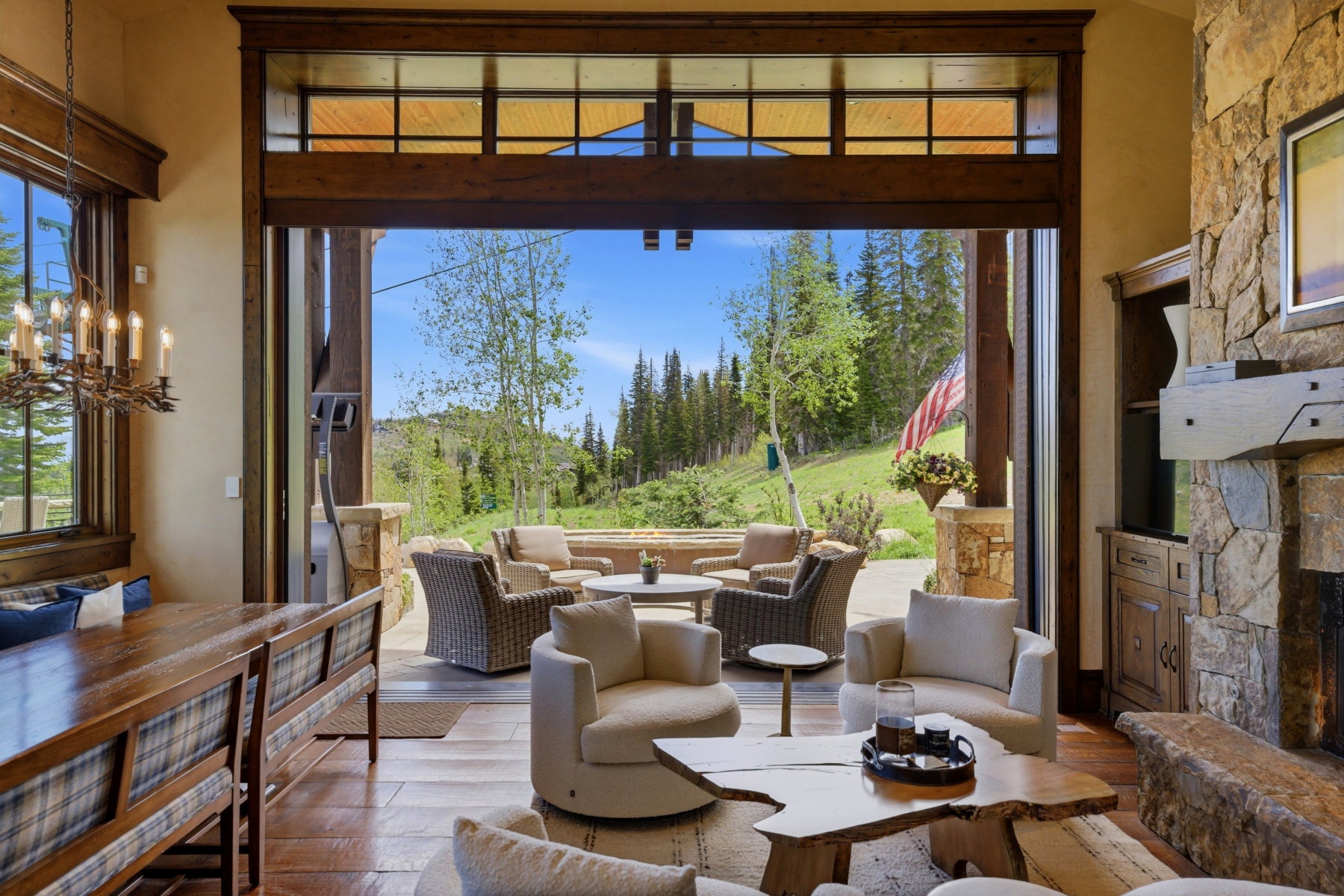 Expansive sliding glass doors opening to an outdoor patio with mountain scenery