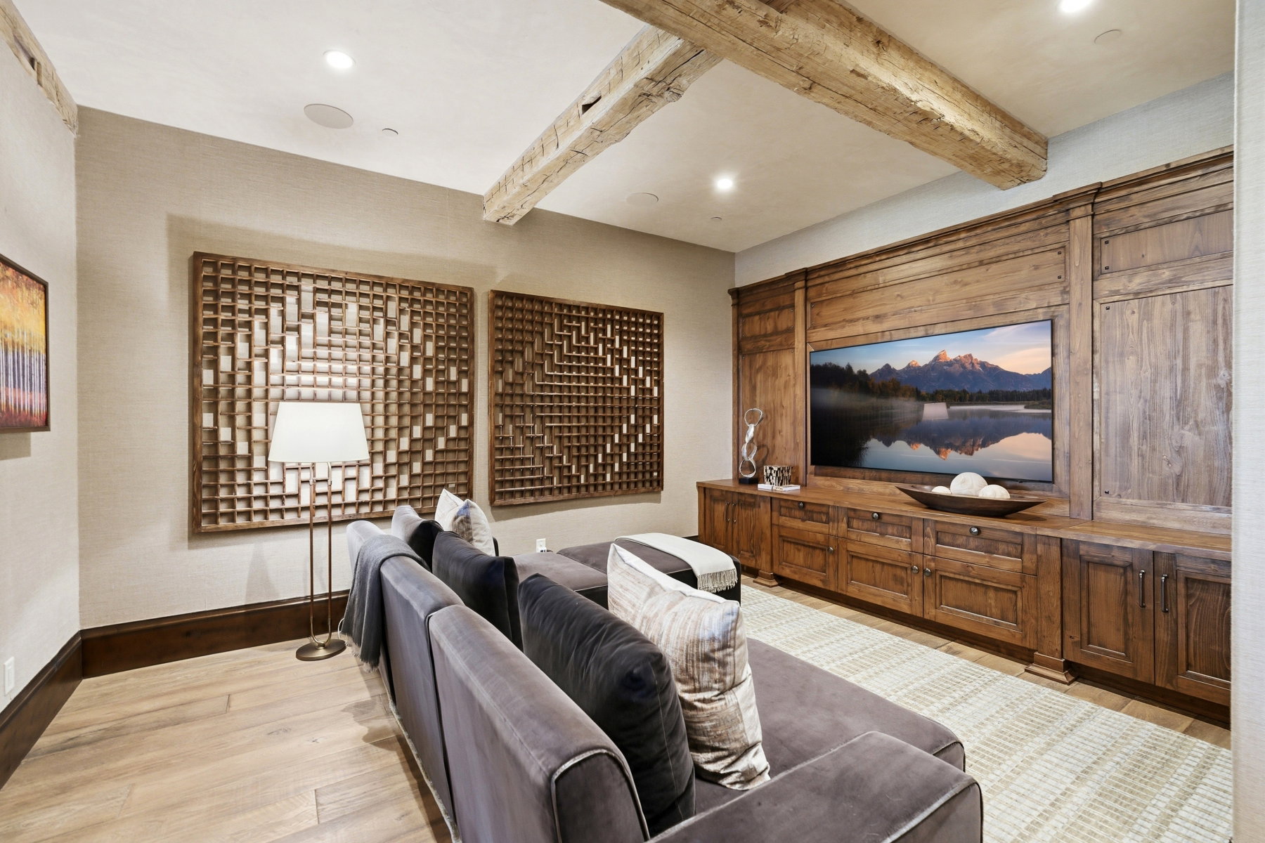 Entertainment space featuring exposed wood beams and recessed lighting