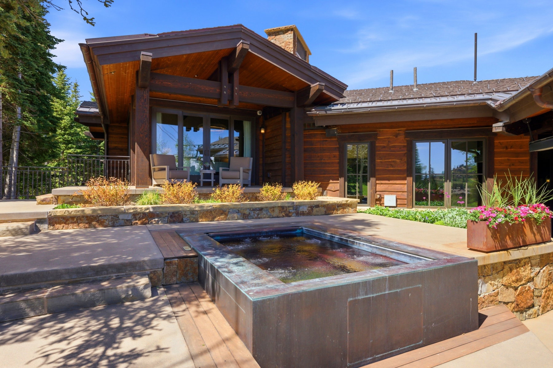 Outdoor spa with stone retaining walls and wood-finish decking
