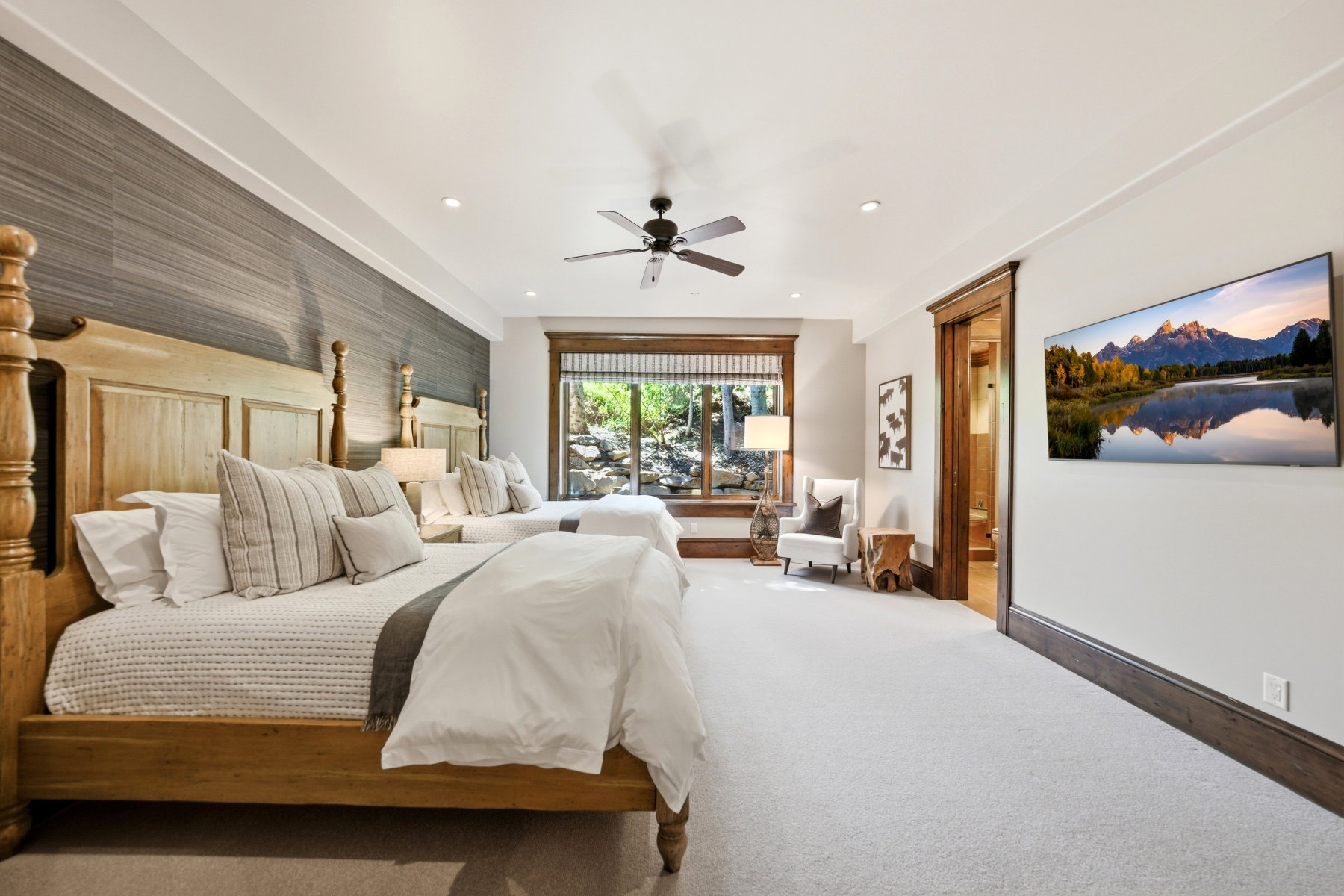 Spacious room featuring light-toned carpeting and substantial wood trim