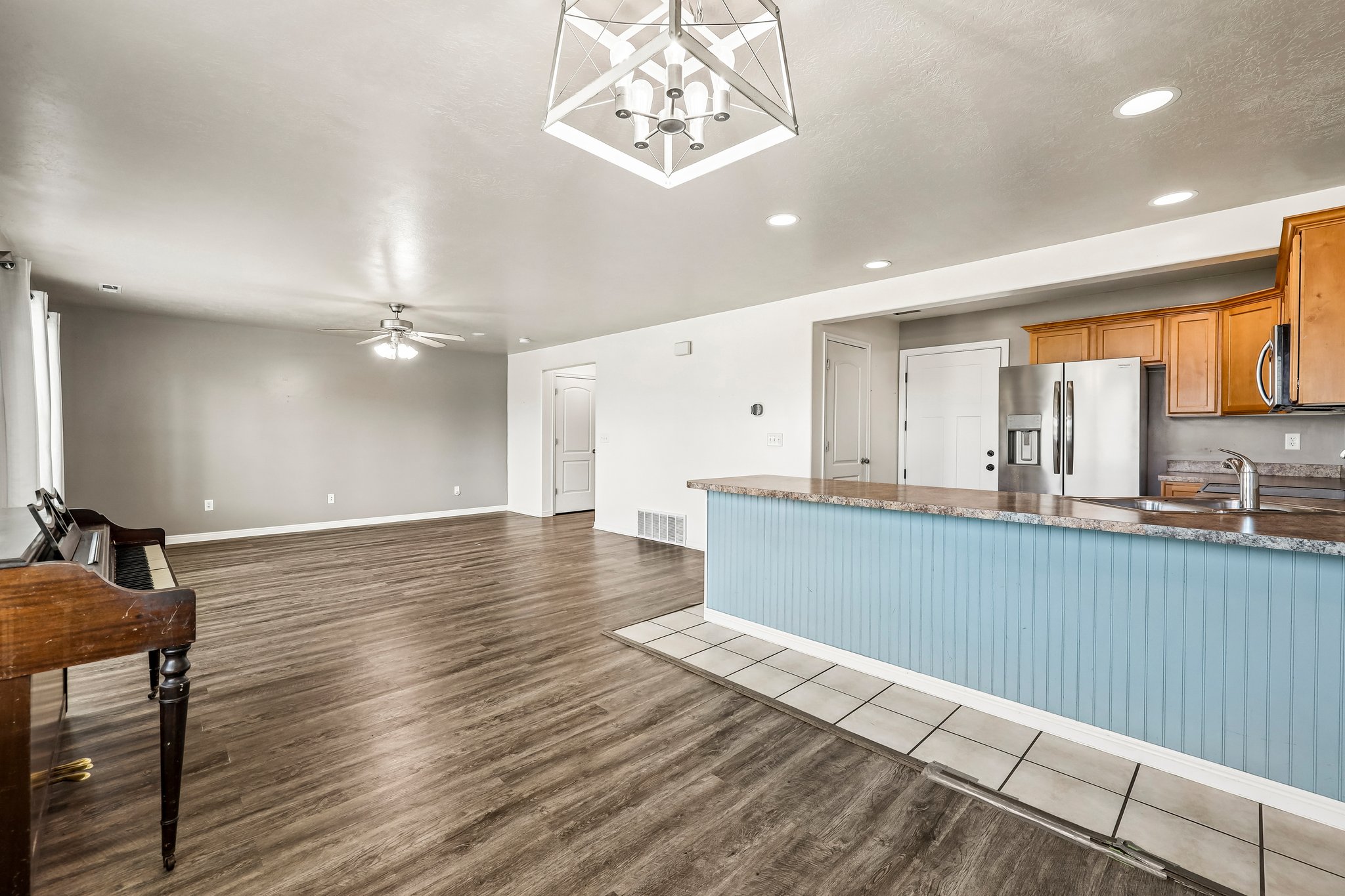 Open-concept living space featuring wood-finish flooring and a ceiling fan