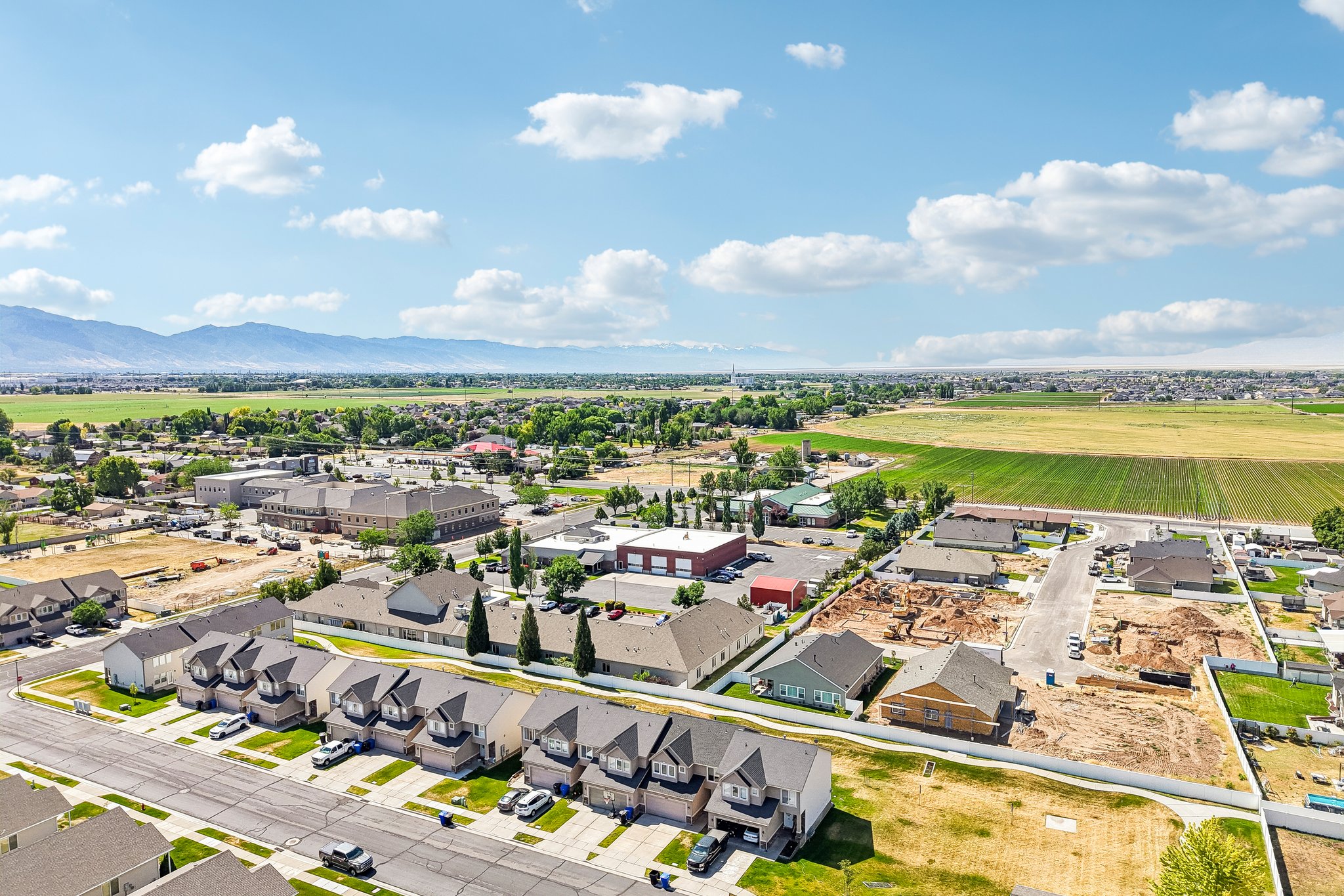 Aerial perspective showcasing a residential development with established homes and active construction sites
