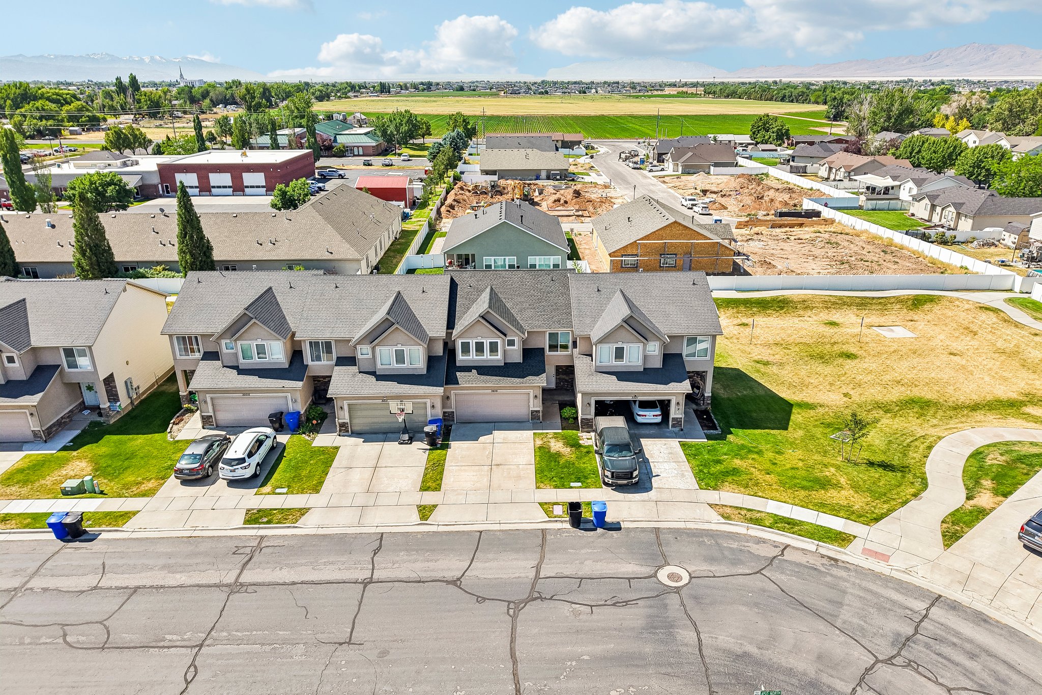 Row of townhomes featuring attached garages and individual driveways