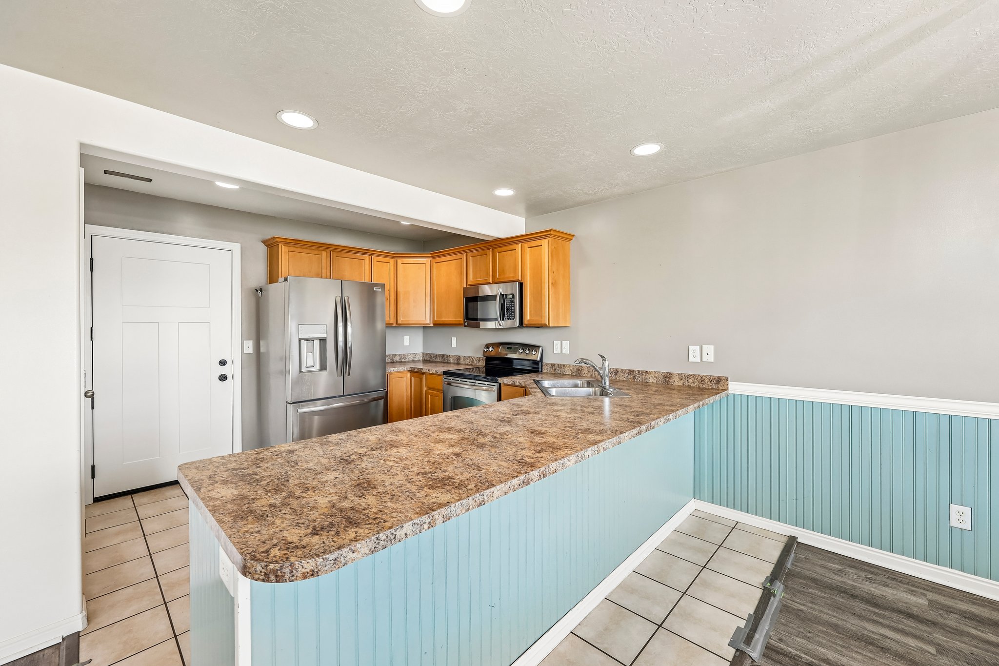 Kitchen featuring wood cabinetry, stainless steel appliances, and recessed lighting