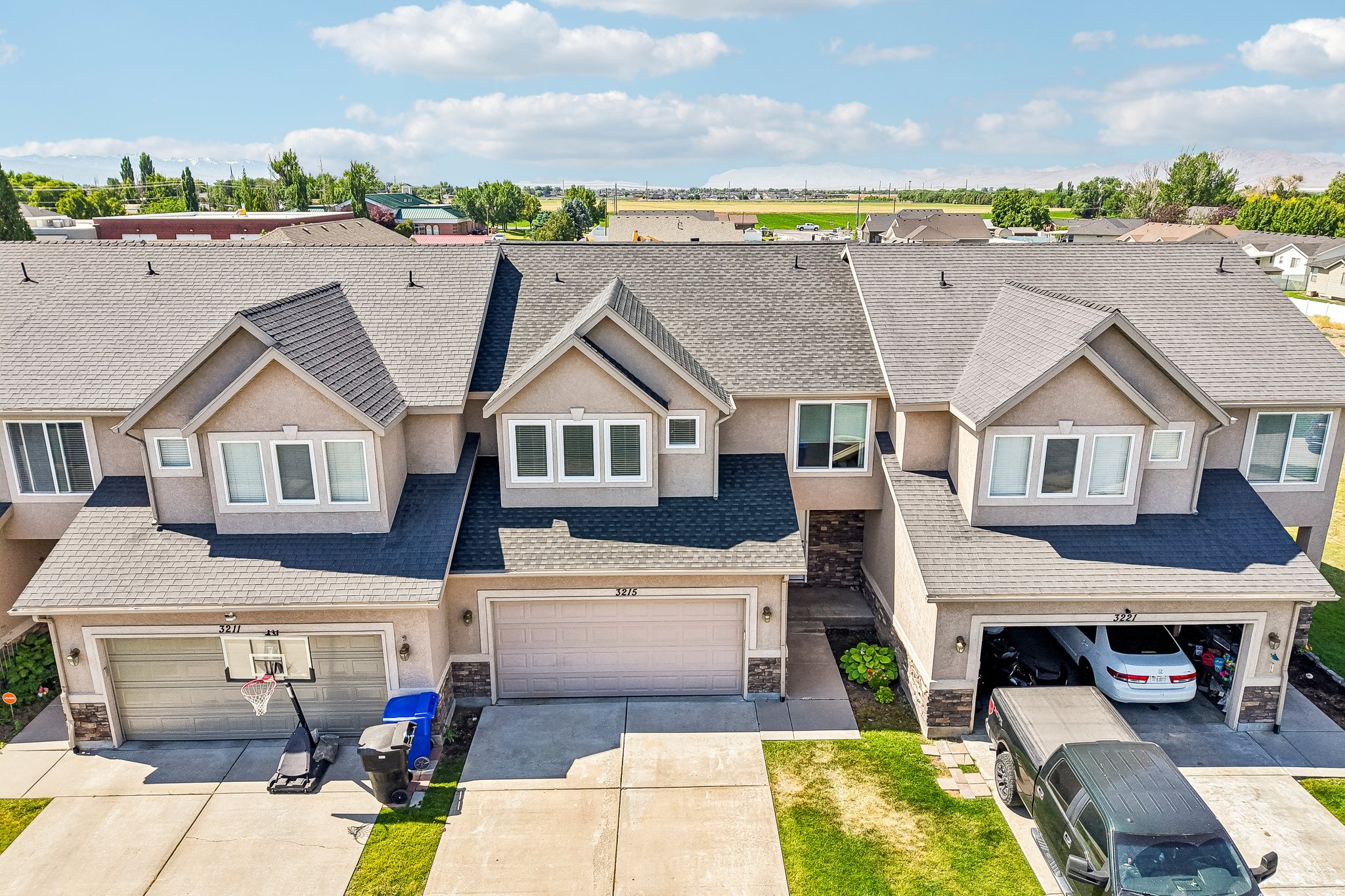 Multi-unit residence featuring stucco siding and stone accents