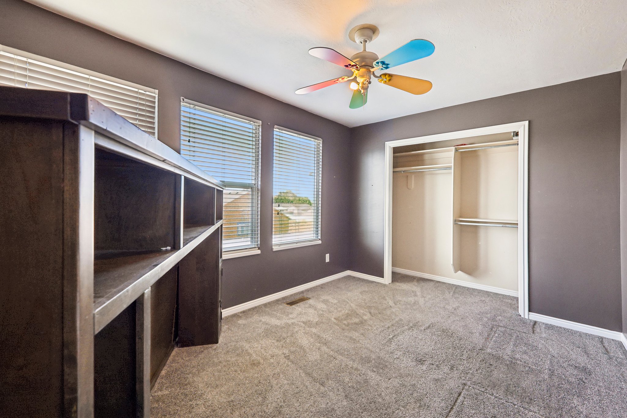 Room featuring gray wall paint, carpeting, and white baseboards