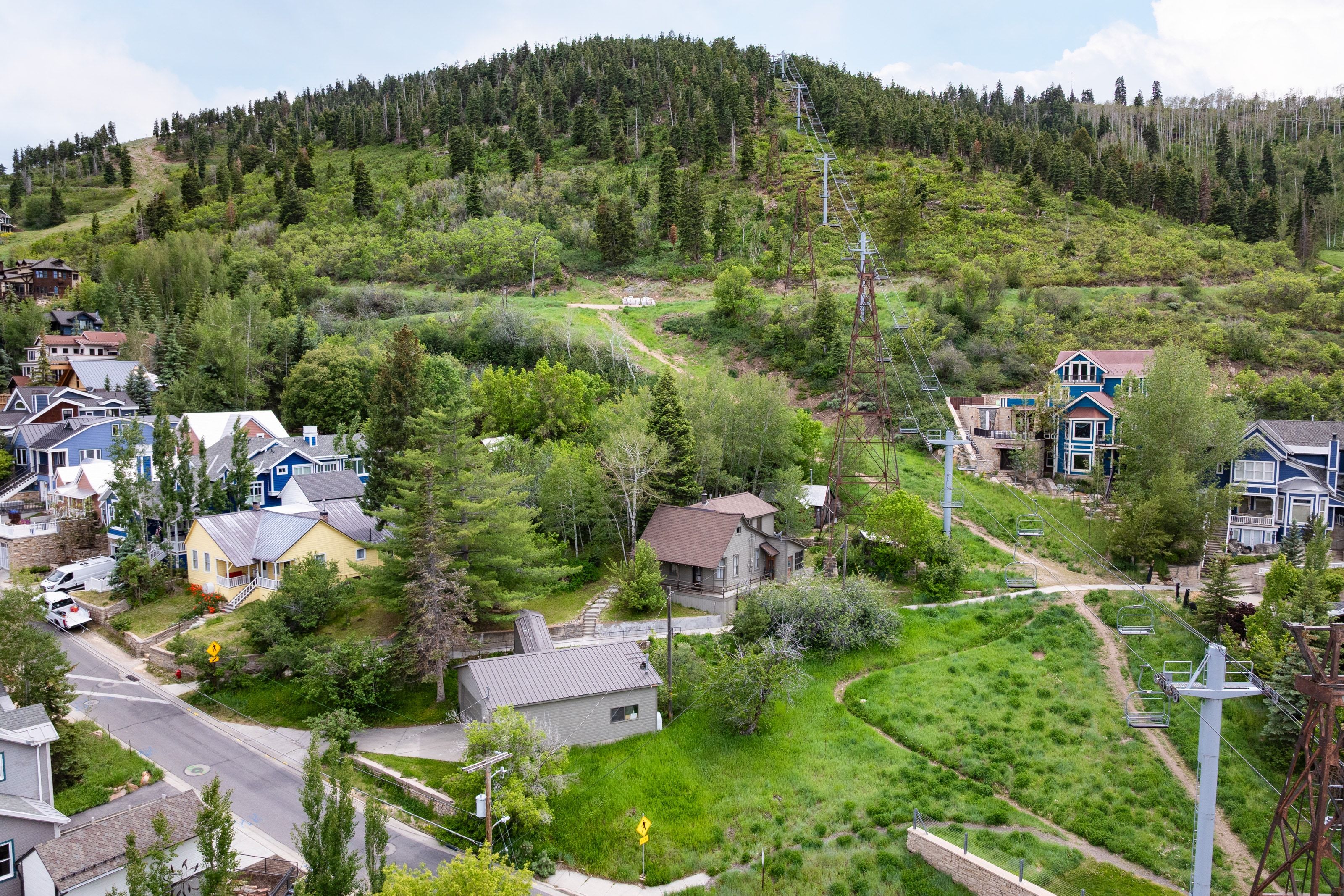 Hillside setting featuring mature trees and lush greenery