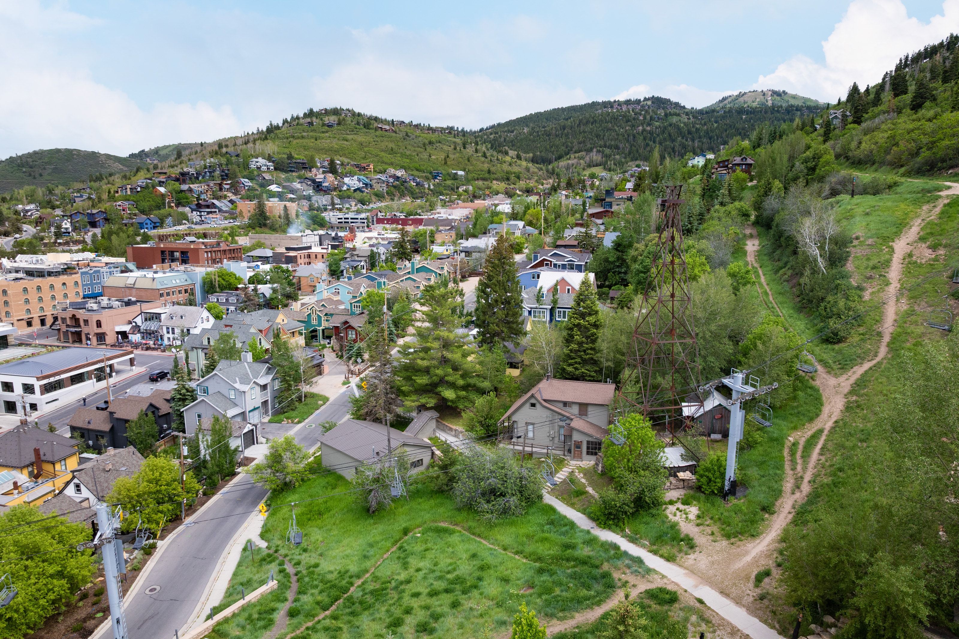 Aerial perspective capturing a mountainside community with varied architectural styles