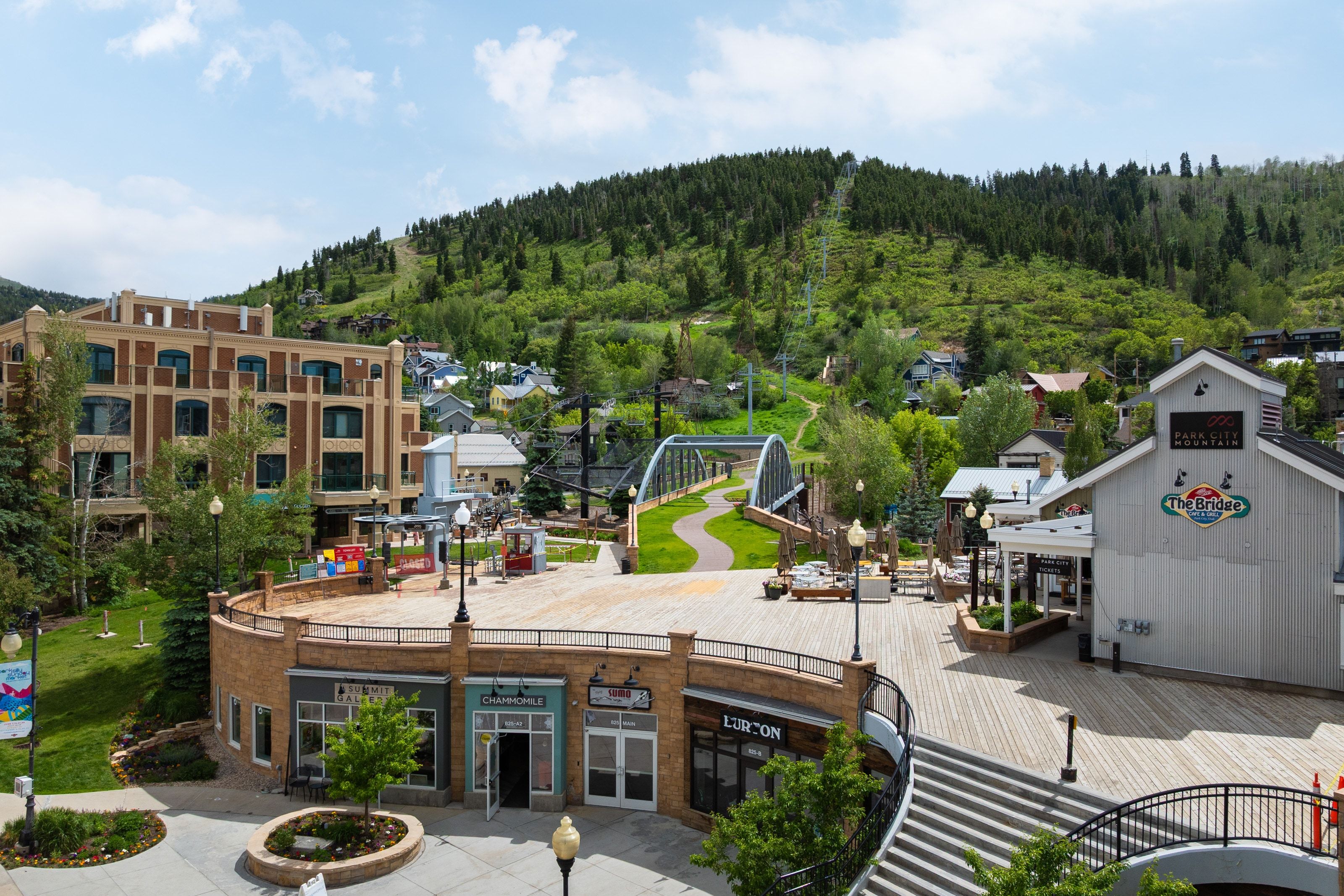 Urban plaza featuring extensive wood-finish decking and integrated stair access