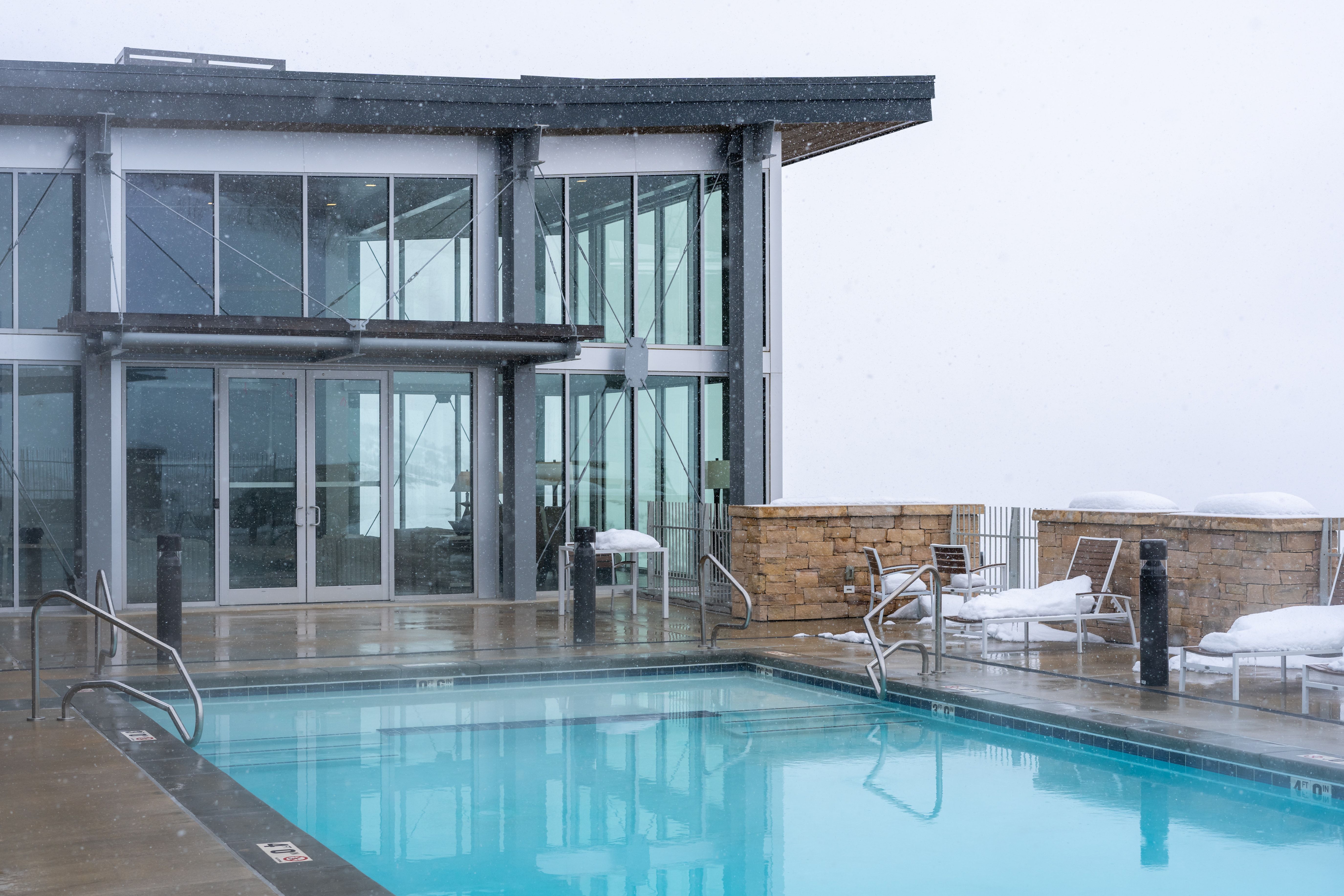Outdoor swimming pool with integrated steps and handrails