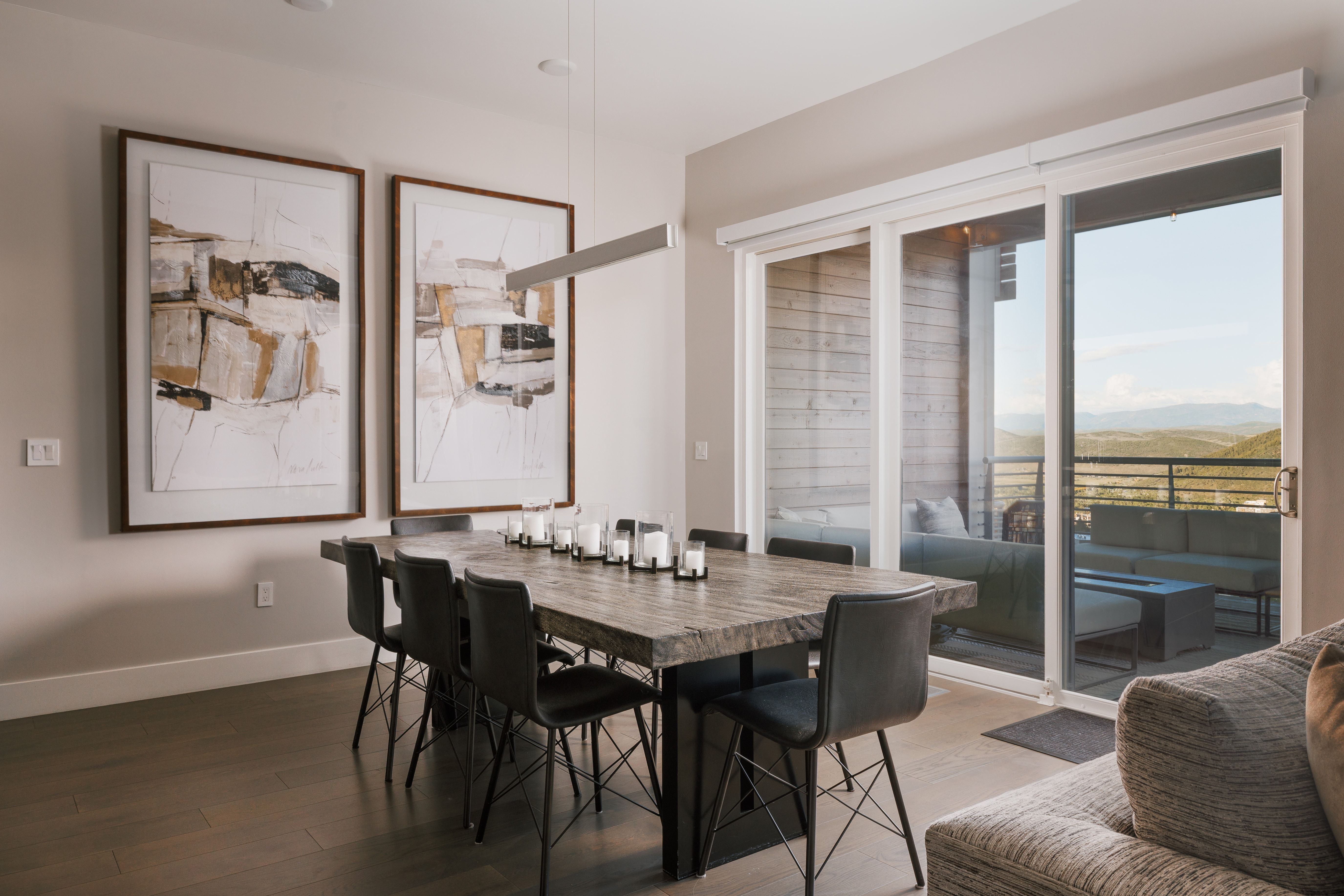 Spacious dining area featuring wood-finish flooring and a linear pendant light fixture