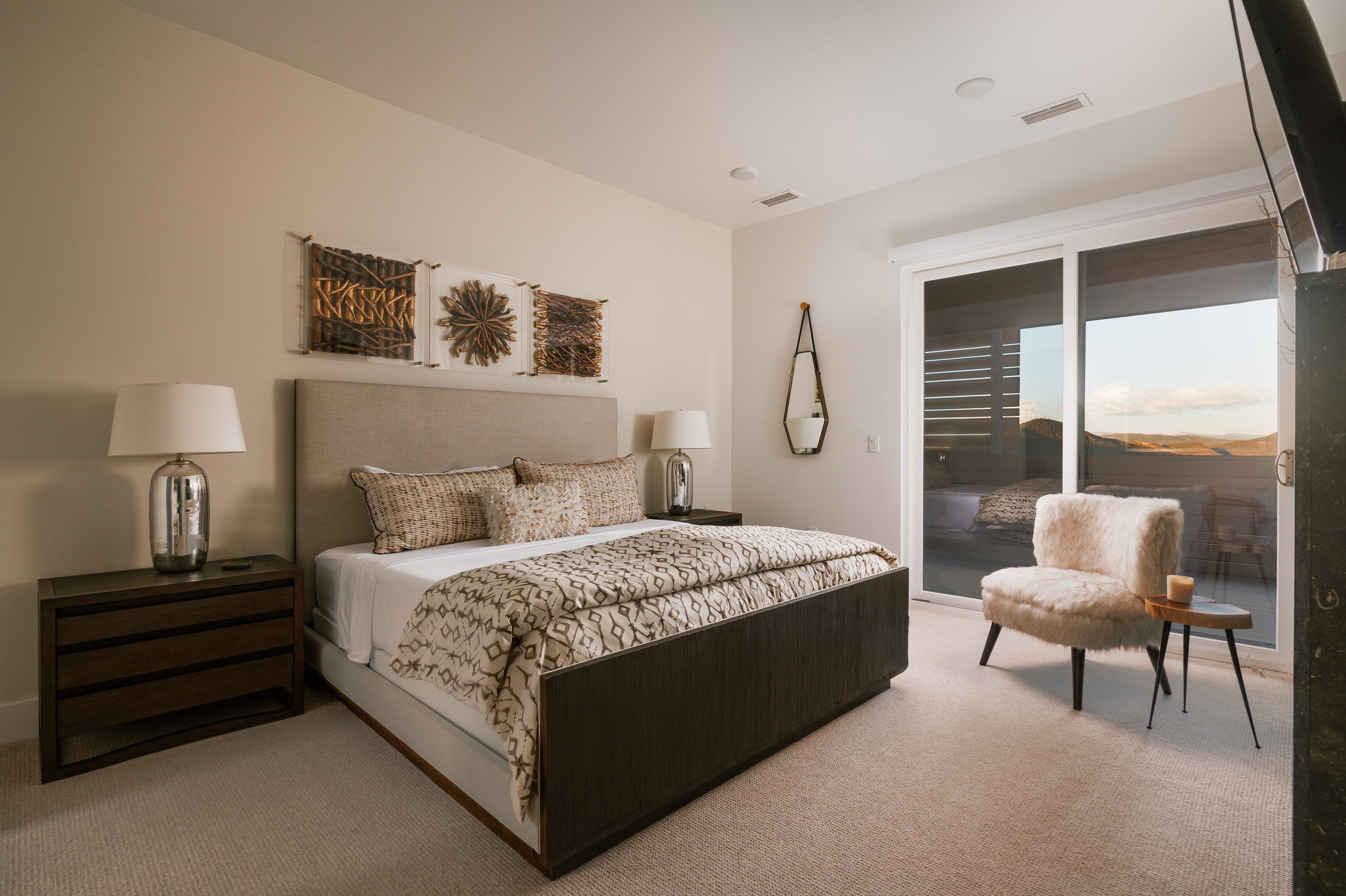 Bedroom featuring neutral wall colors, carpet flooring, a large sliding glass door with exterior access, recessed lighting, and modern wood-finish nightstands