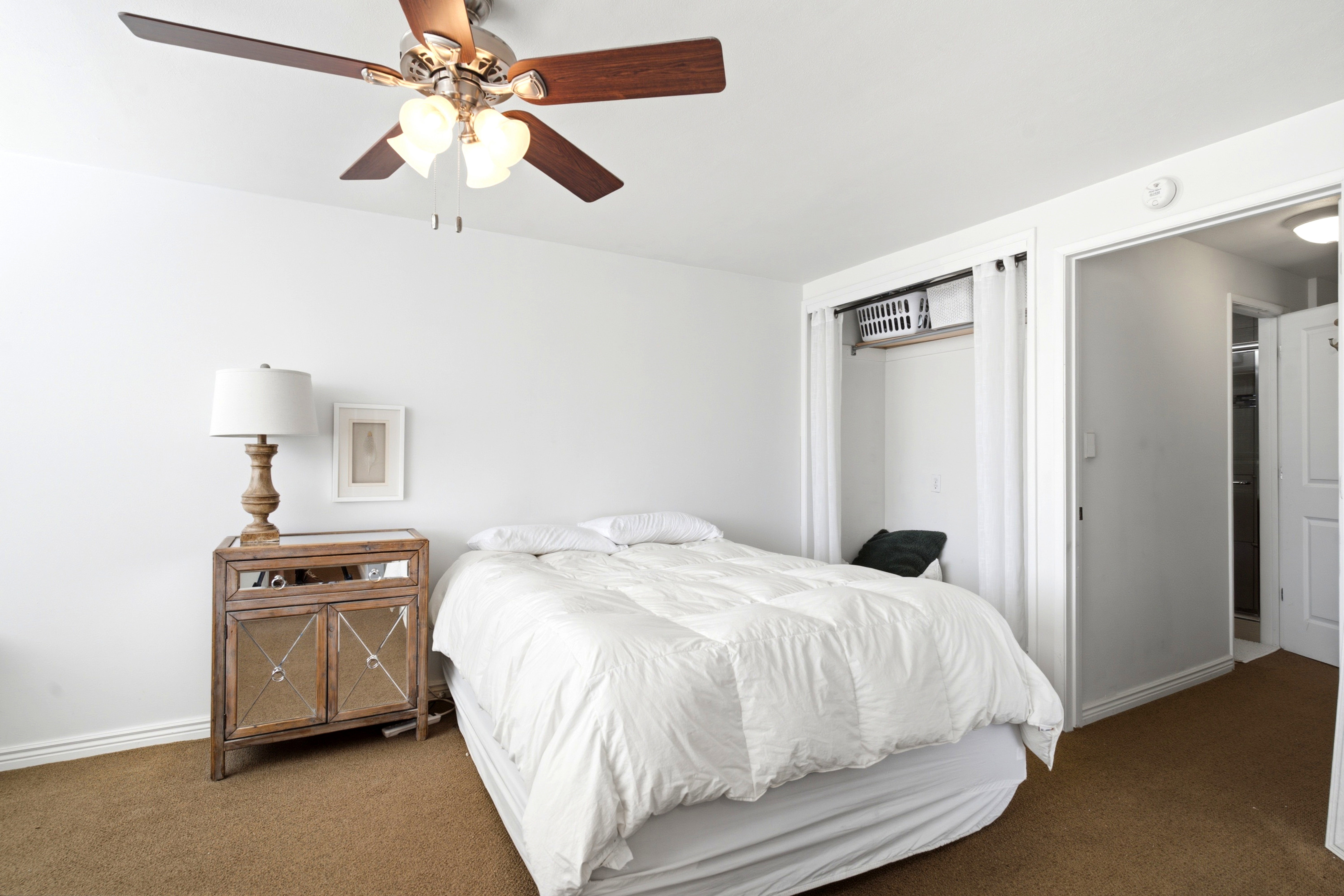 White walls featuring a ceiling fan with integrated lighting