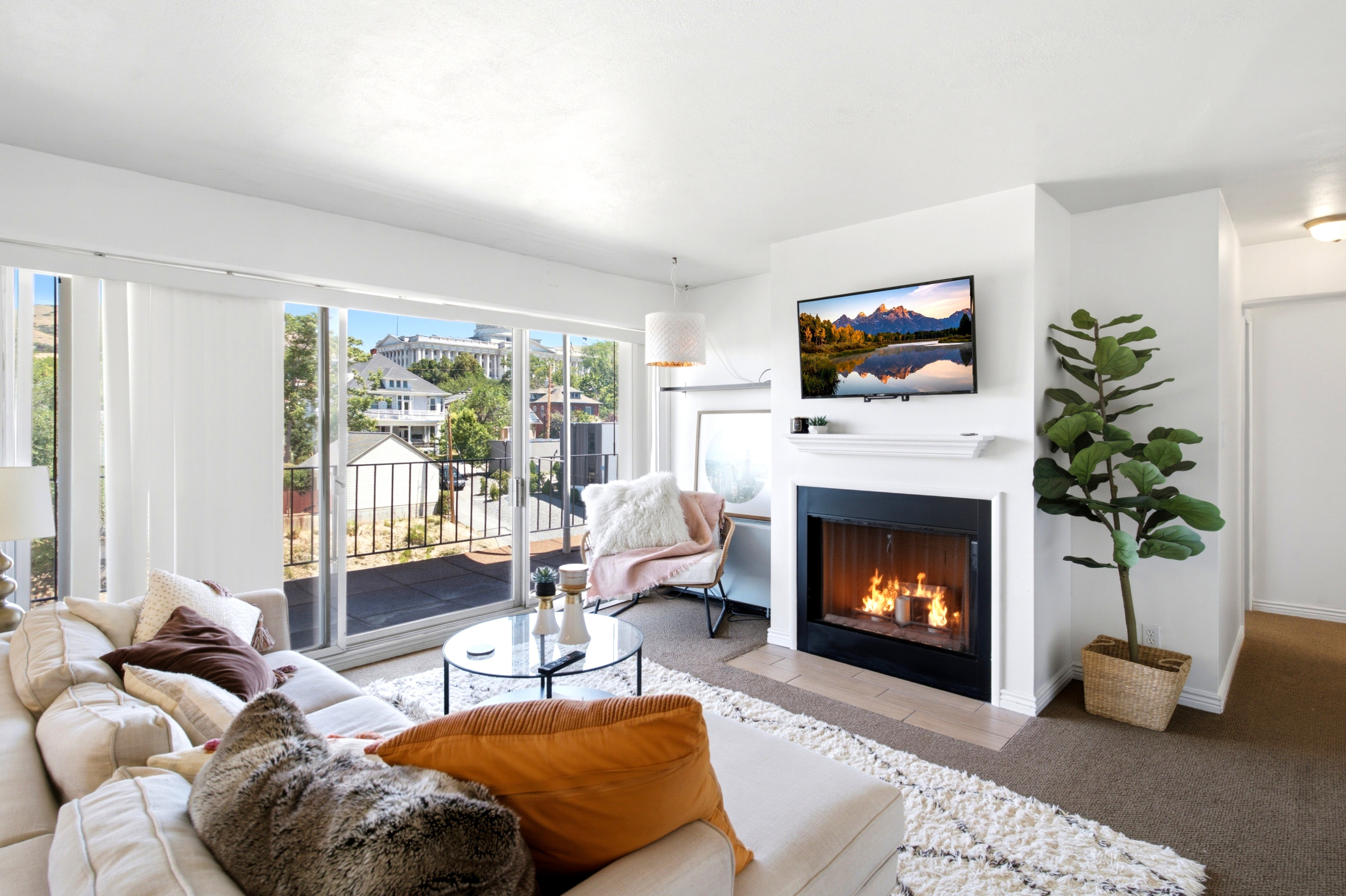 Living area with a fireplace featuring a black firebox and a white mantel