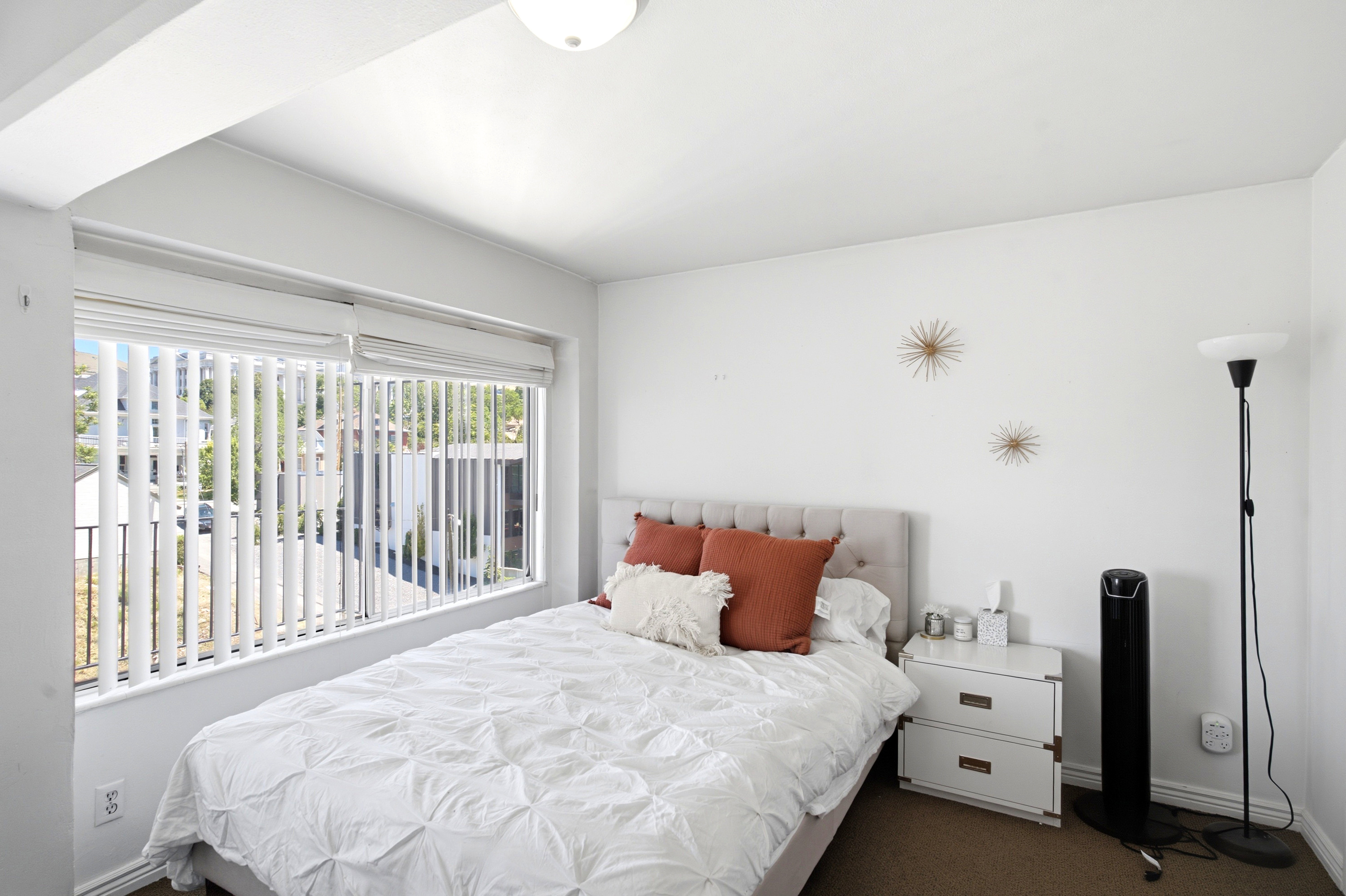 Expansive window with vertical blinds, providing natural illumination