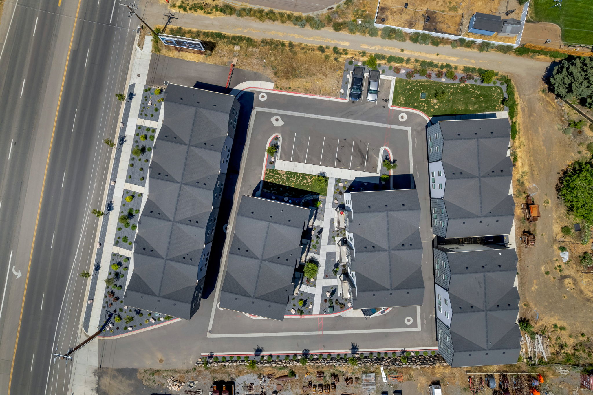 Modern multi-unit development featuring contemporary dark gray roofing