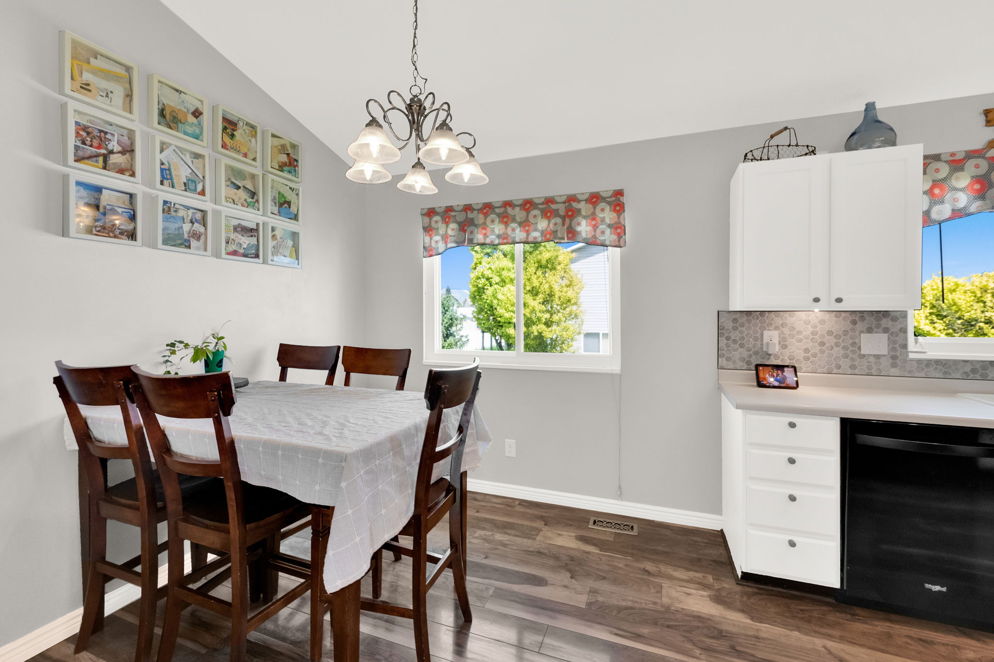 Dining area featuring wood-finish flooring and a decorative chandelier