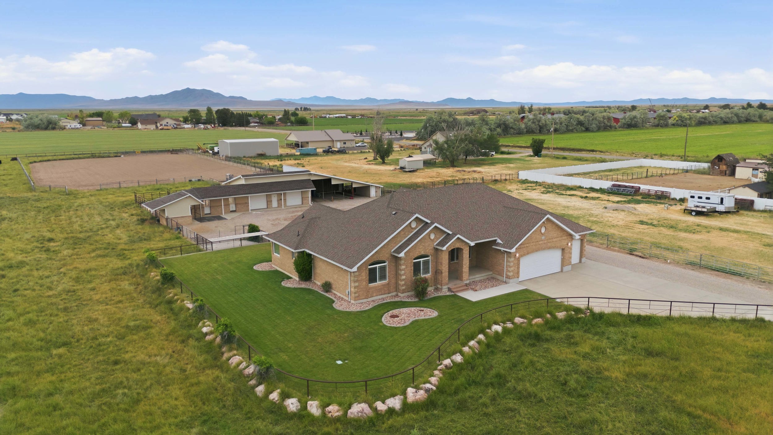 Ranch-style residence featuring a prominent front entrance, attached two-car garage, and a large paved driveway
