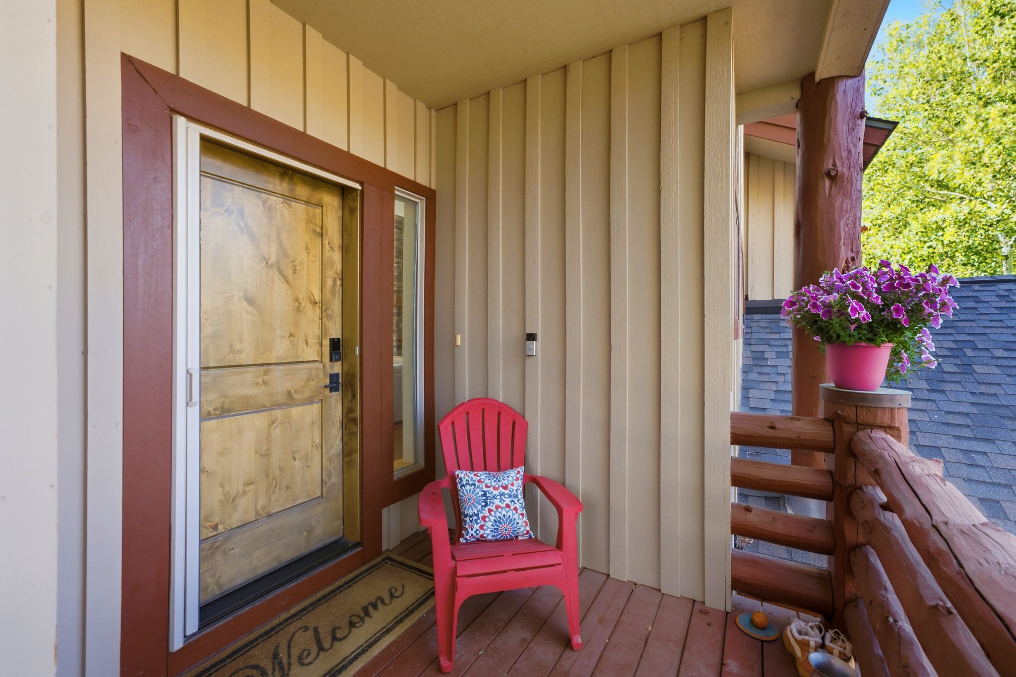 Inviting wood-finish entry door with a sidelight, framed by rich trim