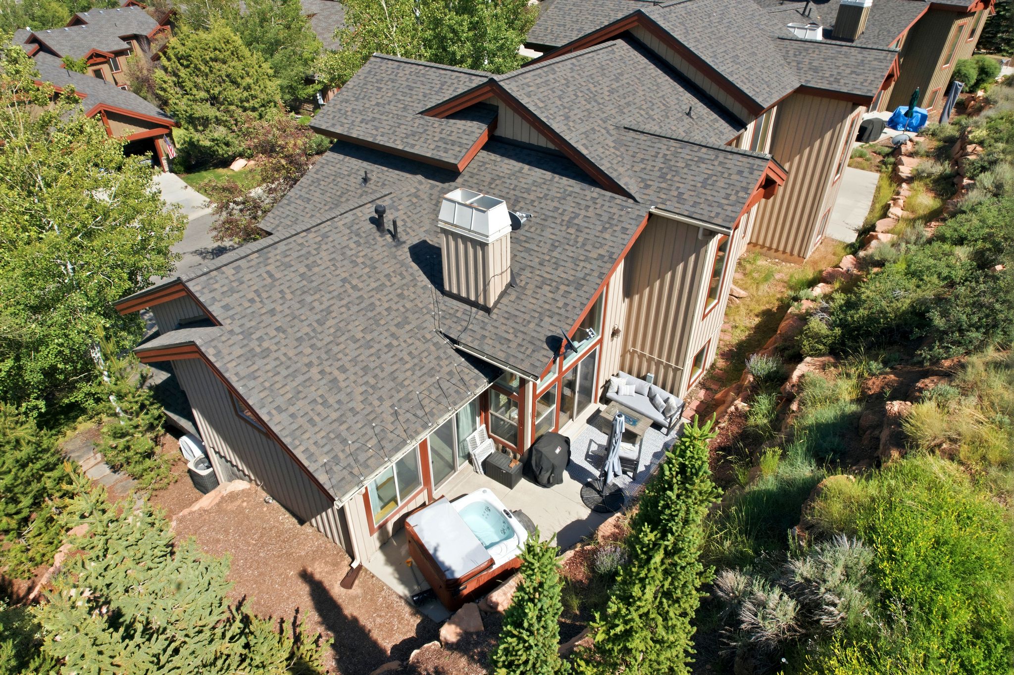 Multi-level property featuring vertical siding and a composite shingle roof