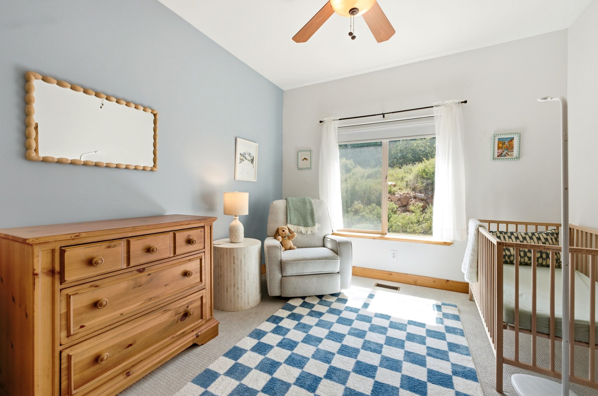 Room featuring a ceiling fan, a window with a wood sill, and light-colored carpeting