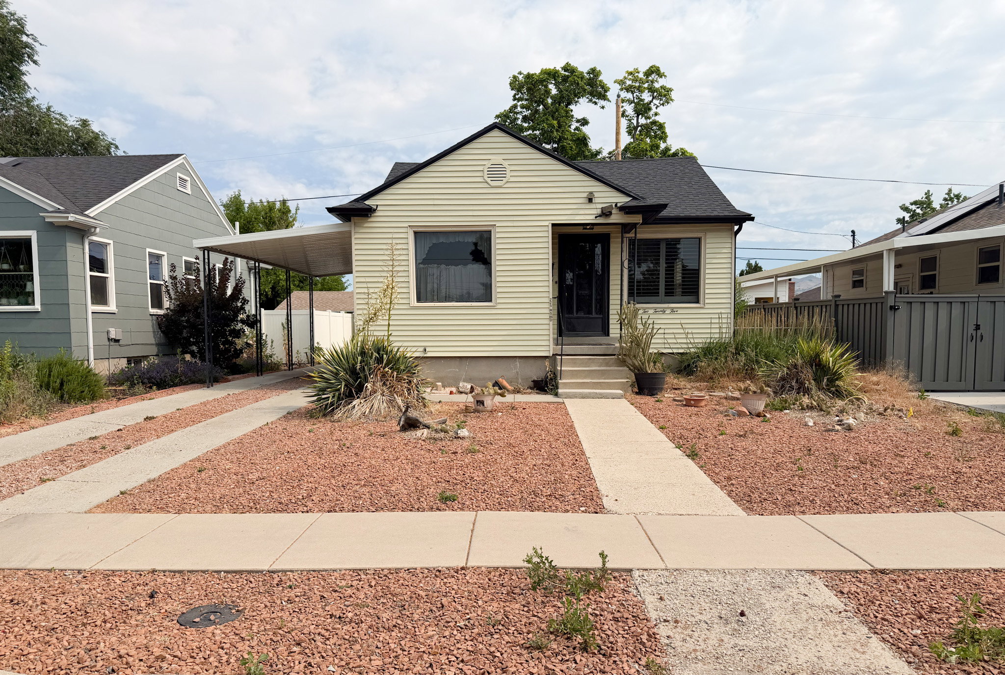 Front of Home featuring Carport with Garage behind