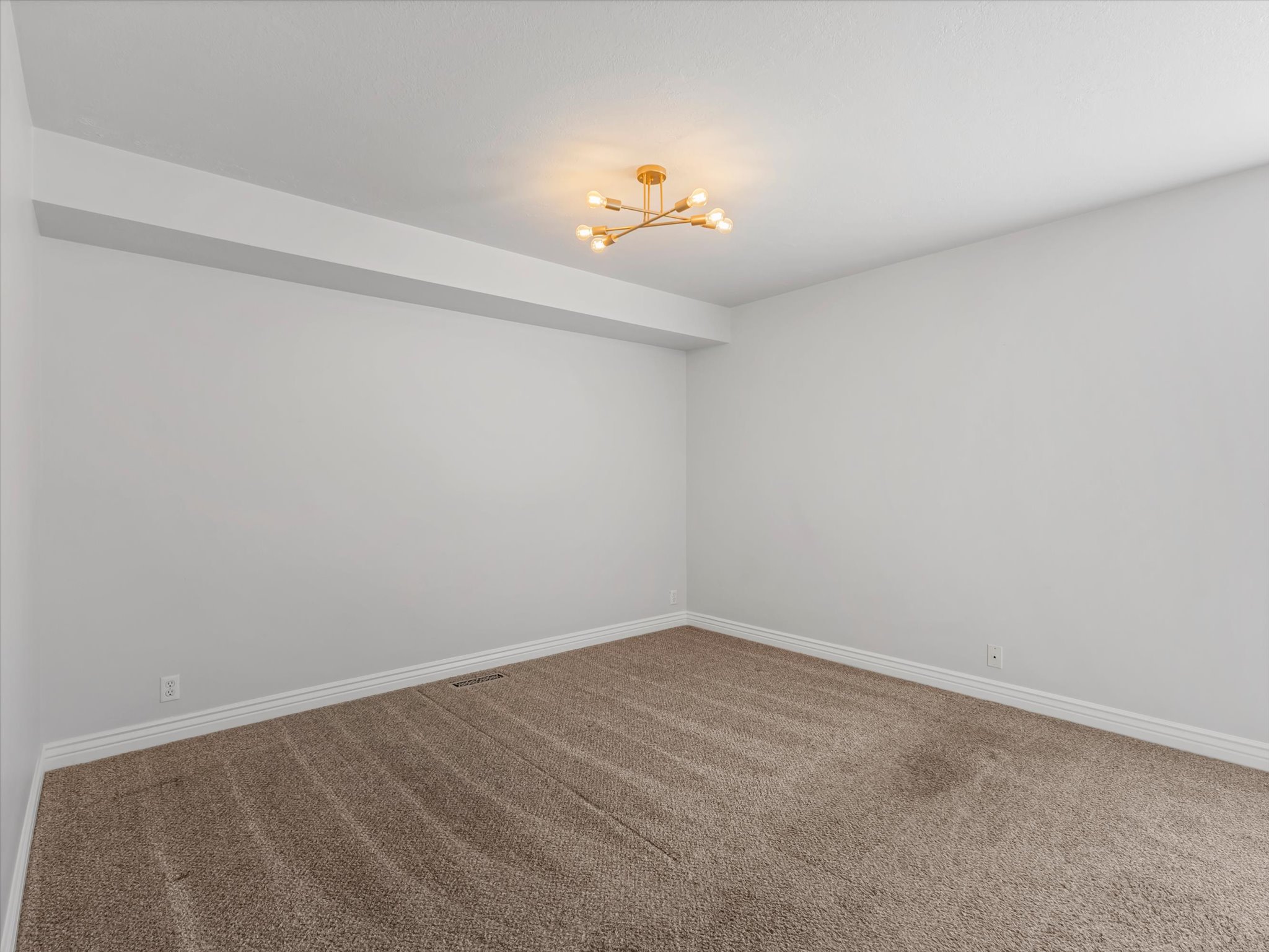 Neutral-toned carpeting paired with white baseboards