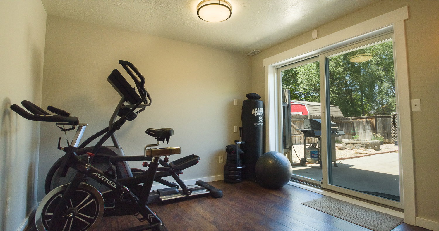 Room featuring wood-finish flooring, recessed lighting, and a sliding glass door providing direct access to the exterior patio