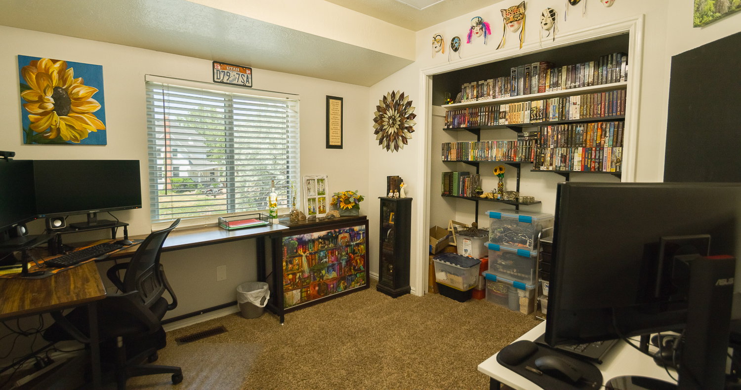 Room featuring carpet flooring and a window with horizontal blinds