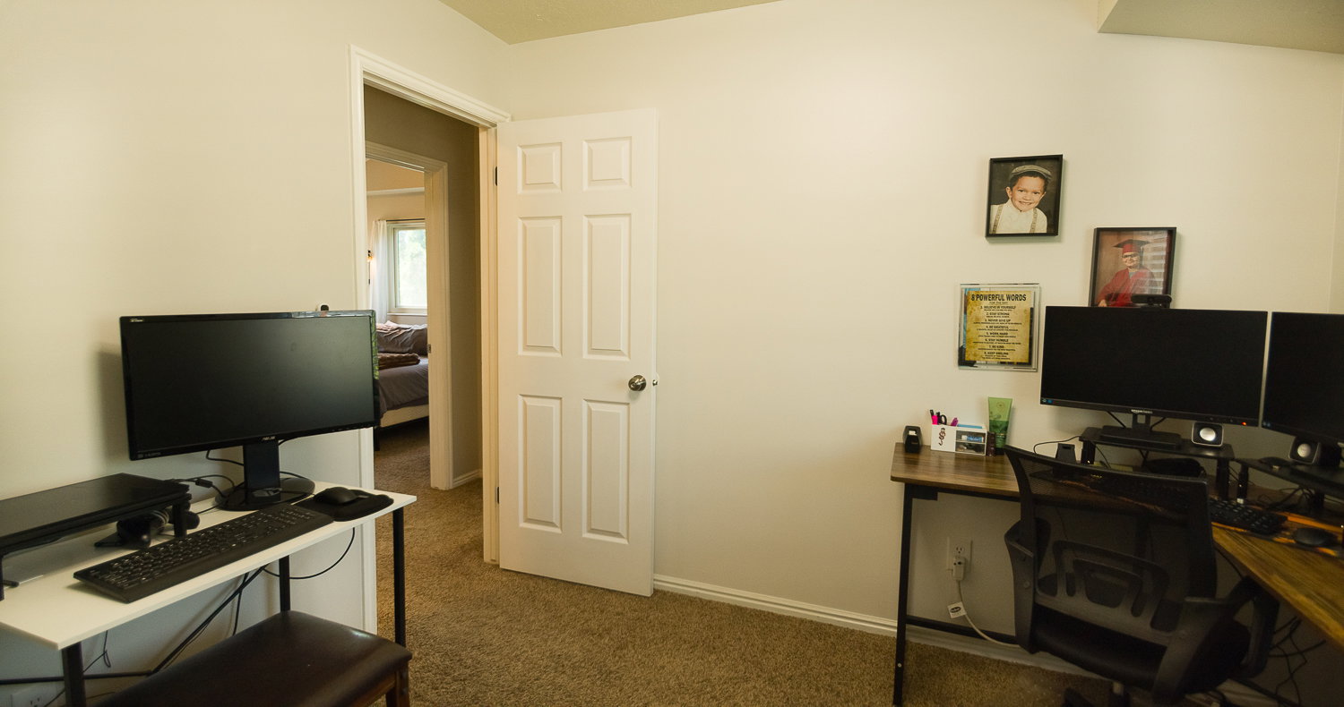 Carpeted room with light neutral wall paint and white trim