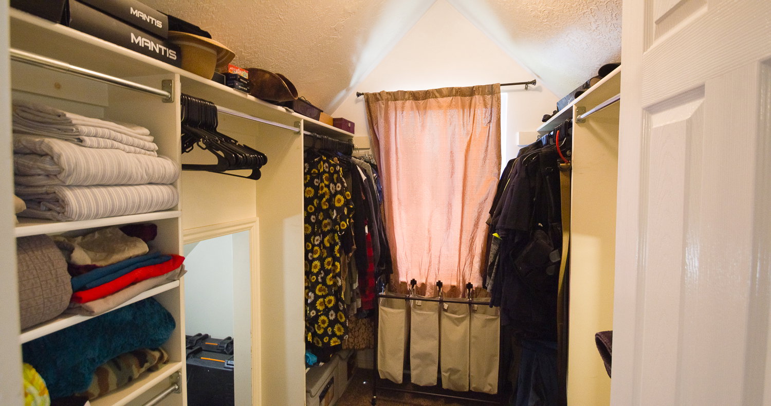 Custom closet organization system featuring built-in shelving and hanging rods