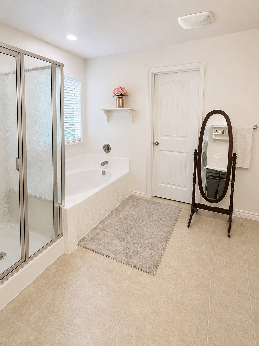Full bathroom featuring a glass-enclosed shower, a deep soaking tub, and neutral tiled flooring