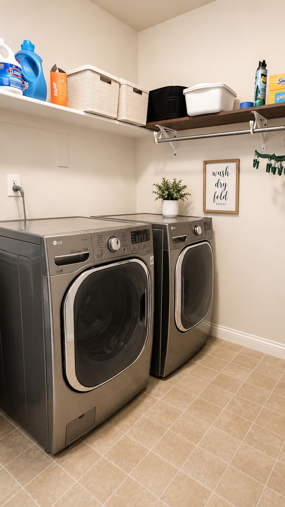 Dedicated laundry area featuring beige tiled flooring, a pair of wall-mounted white shelving units, and an additional wall-mounted dark wood-finish shelf with an integrated hanging rod