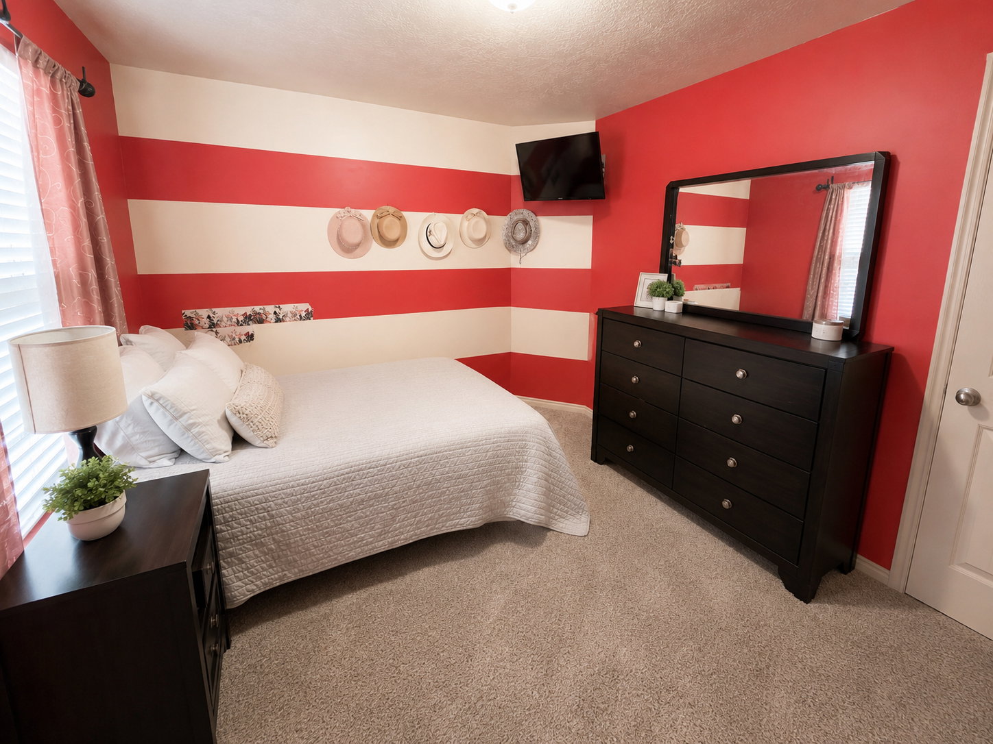 Room with horizontal red and white striped accent wall
