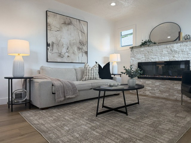 Living area featuring a textured stone-finish fireplace with an integrated linear electric insert, recessed lighting, and wood-finish flooring