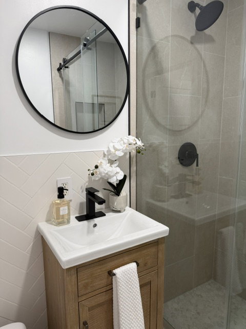 Contemporary vanity with integrated sink, matte black faucet, and wood-finish cabinetry