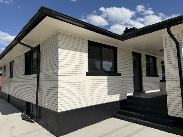 White brick exterior with contrasting black trim