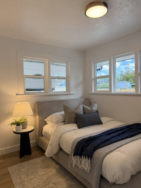 Bright room with multiple windows and wood-finish flooring