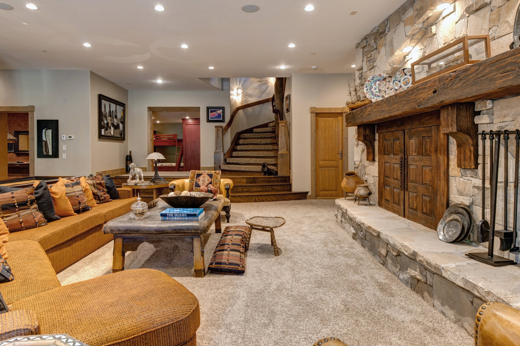 Stone fireplace with a substantial timber mantel and hearth