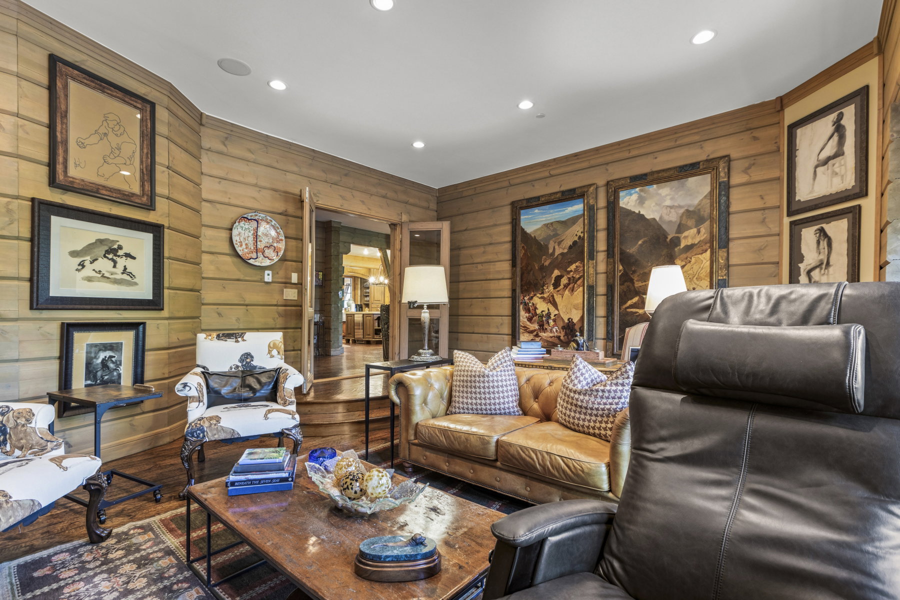 Living area featuring horizontal wood paneling, recessed lighting, and wood-finish flooring